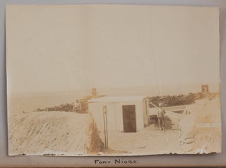 [Album with 33 Original Gelatin Silver and Albumen Photographs, Taken and Collected by an Officer of HMS Niobe during the Second Boer War and Showing the Defence Installations in Walvis Bay (Fort Niobe, Cuddy Cop, Fort Stocker), Artillery and Maxim Guns, Cape Garrison Artillery Camp in Walvis Bay, HMS Niobe, Its Officers and Crew, Boer Prisoners and Their Tent Camp on Saint Helena, Imprisoned Boer General Piet Cronje, Governor of Walvis Bay, et al.; with Two Ink-Drawn “Plan of Settlement Shewing Fortifications and Defences Forming Fort Niobe, Erected by Naval Brigade from HMS “Niobe” for Defence of Settlement from Boer Raids, Feb. 10th-14th 1900;” and “Plan of the Boer Enclosure and Deadwood Camp, St. Helena, 1900”].