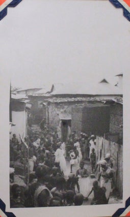 [Album with 196 Original Gelatin Silver Photos of Ghana (Accra, Aburi) and Eritrea (Asmara, Massawa, Cheren) Taken by a U.S. Air Force Serviceman in the Last Years of WWII, with Interesting Photos Including a “Witch Doctor Scaring away Evil Spirits After a Death of a Native,” G. I.’s Sharing Cigarettes with the Crowd of Locals, Native Women Shopping in their Traditional Attire, Soldiers “Getting Shoes Shined” by the Local Children & Holding Burst Shells on the Cheren Battlefield, etc.; also with the Photos of Military Installations, the Church of Our Lady of Rosary, the Asmara Cinema, Red Cross & Grand Hotels, etc.]