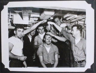 [Album with 106 Original Gelatin Silver Photographs of the USCGC Eastwind’s Annual Summer Cruise to Greenland (Thule Air Force Base, Cape Etoh, Grondal, and Godthab) Showing American & Canadian Vessels (USS Glynn, USCGC Westwind, and Labrador), Prominent Arctic Explorer Donald Macmillan, a Helicopter Crash Landing on the Ice, “Frog Men” Preparing for Underwater Dynamiting, Local Eskimos Posing with the Captain Rhanke, etc.; Also with the Images of Sailors Meeting Danish Admiral on the Fourth of July, Having a Beer Party, and Celebrating the Initiation Ceremony in Costumes.]